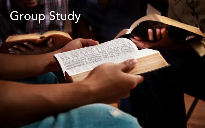 Open hardcover bible with aged, yellowed pages and black printed text.
