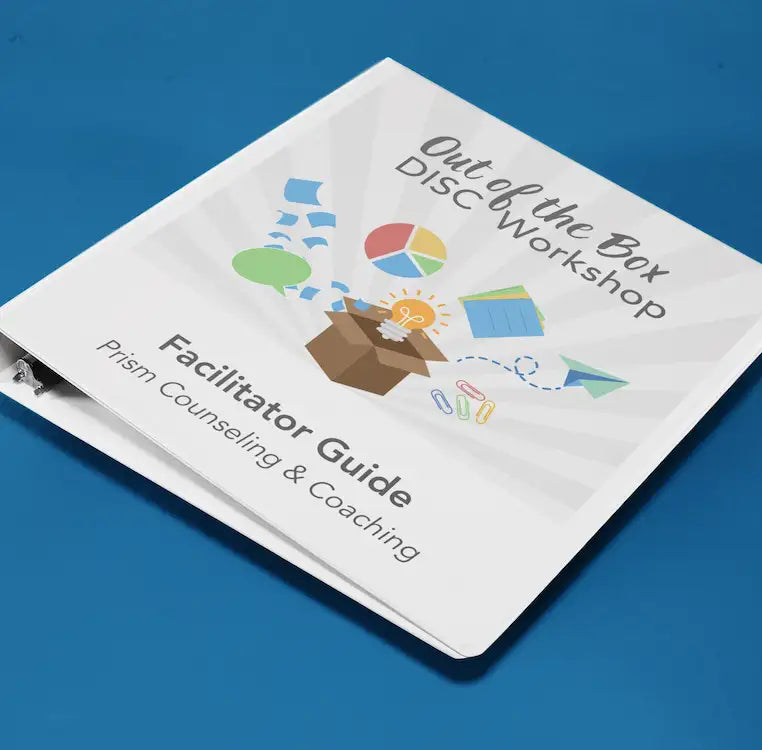 White binder with colorful graphic cover for the ’out of the box disc workshop facilitator guide’ by prism counseling & coaching.